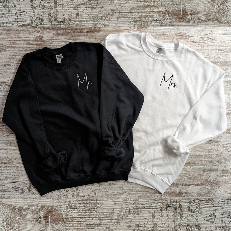 Matching Mr. and Mrs. embroidered crewneck sweatshirt set: black Mr. sweatshirt and white Mrs. sweatshirt with script embroidery